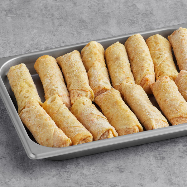 A tray of Gourmet Egg Roll Co. Pizza Egg Rolls on a table.