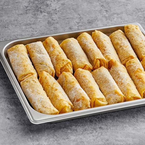 A tray of Gourmet Egg Roll Co. shrimp egg rolls on a gray surface.