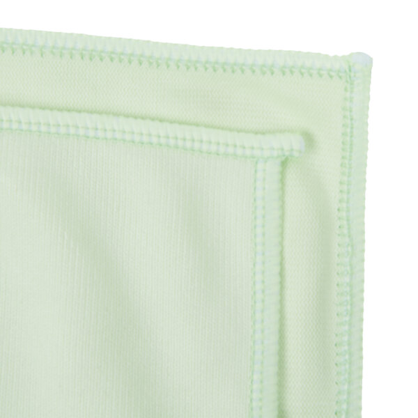 A close up of a green microfiber cloth with white stitching.