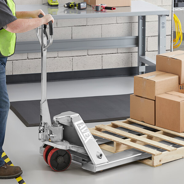 A man holding a Lavex stainless steel pallet jack.