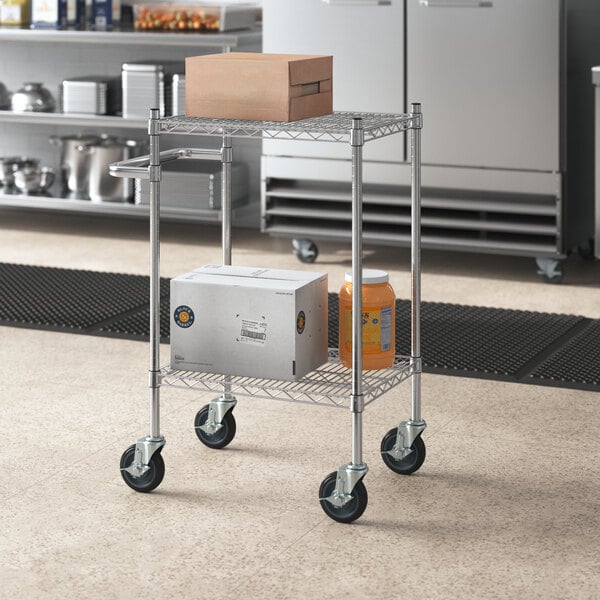 A Regency chrome utility cart with boxes on the shelves.