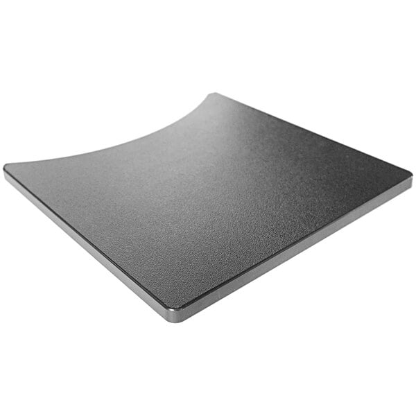 A black square cutting board with curved edges for a Gateway Drum Smoker