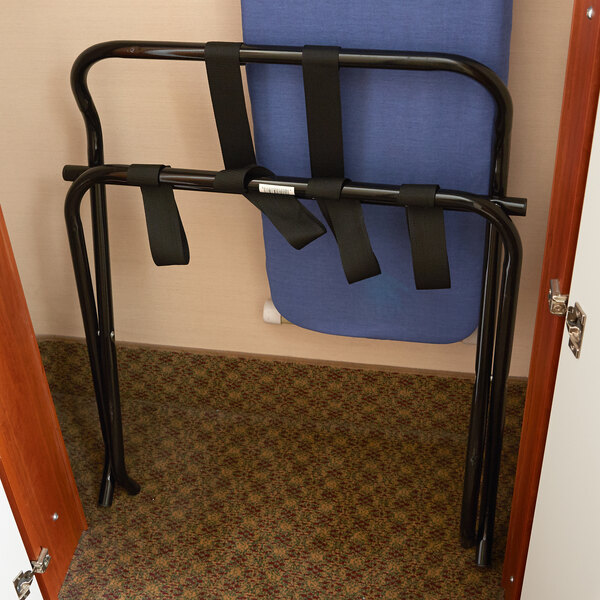 A Lancaster Table & Seating black folding luggage rack with black straps on a metal frame.