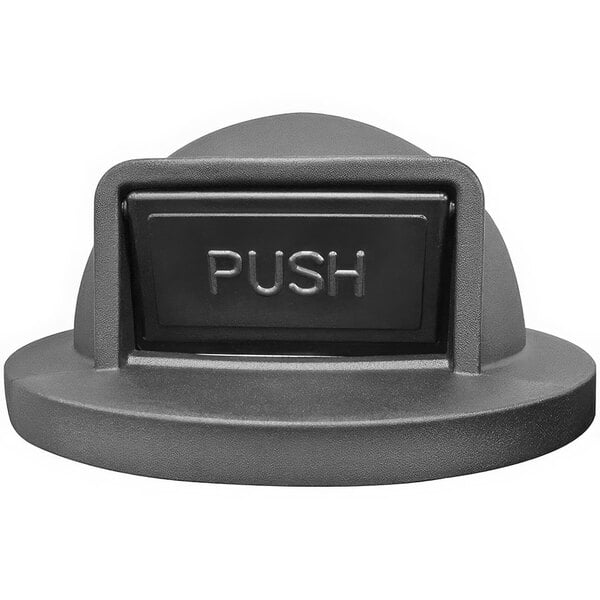A close-up of a black push button on a grey background.