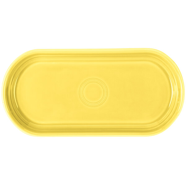 A yellow oval bread tray with a circular sunflower design in the middle.