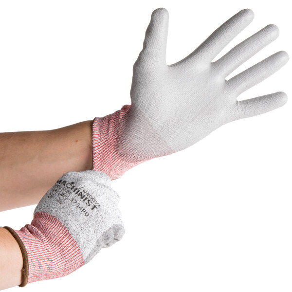 A person wearing Cordova Machinist cut-resistant gloves with a gray palm.