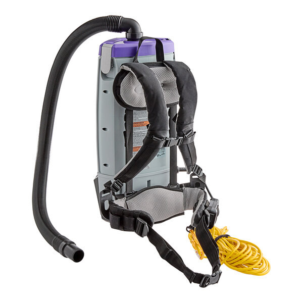 A ProTeam backpack vacuum with a hose attached.