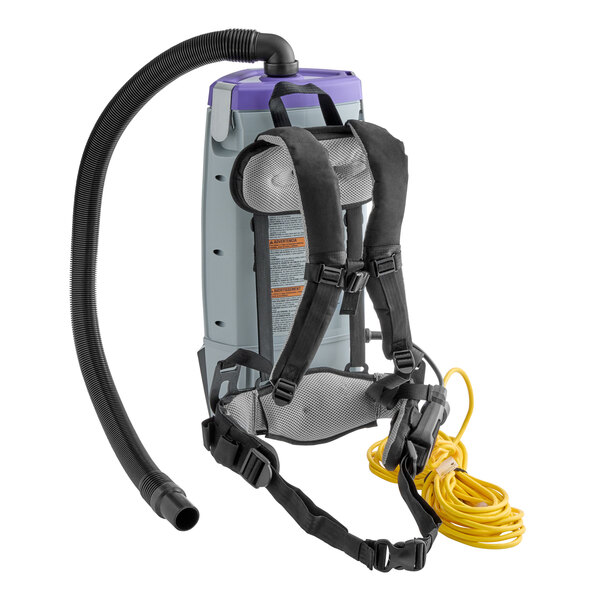 A ProTeam backpack vacuum with a hose attached.