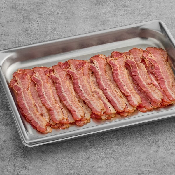 A tray of Swift Fully Cooked Thin Bacon slices on a gray surface.