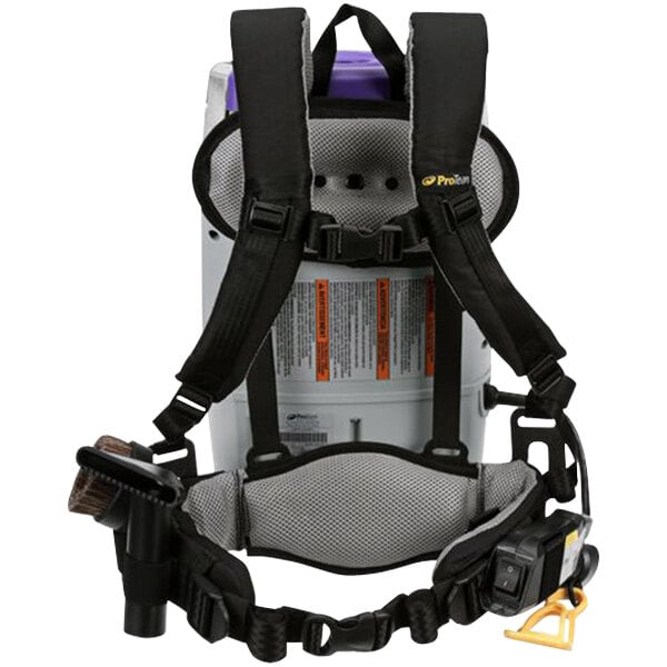 A ProTeam Super Coach Pro backpack vacuum with a telescoping wand and floor tool attached.