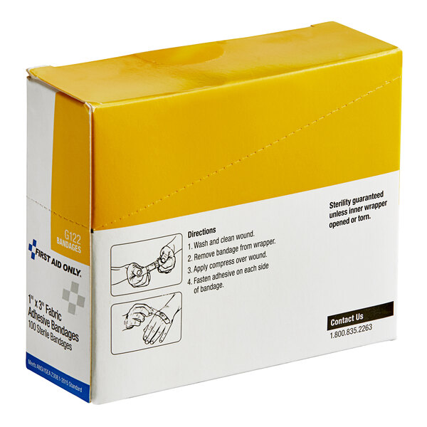 A yellow and white First Aid Only box of fabric bandages.