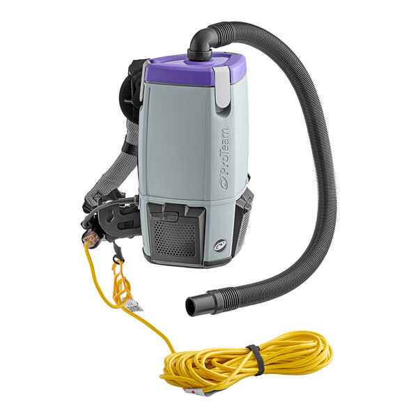A ProTeam backpack vacuum with a hose and attachments in a white plastic case.