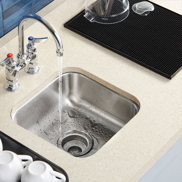 A Waterloo stainless steel undermount sink running water.