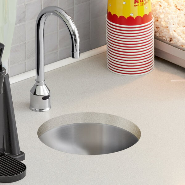 A Regency undermount sink with a bucket of popcorn on the counter.