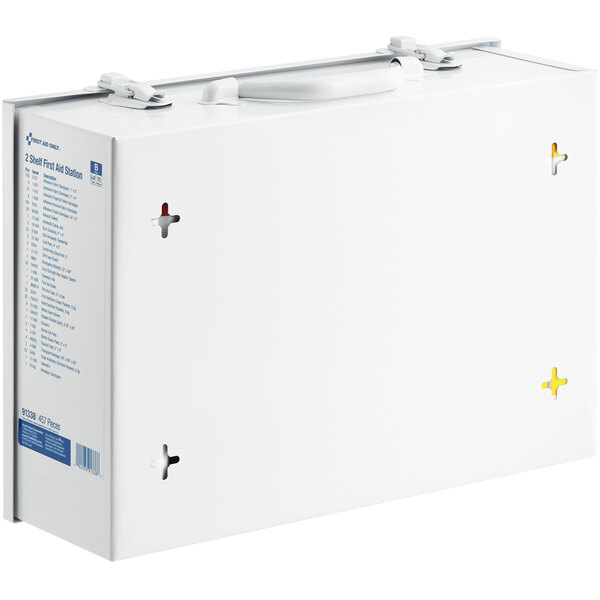 A white First Aid Only cabinet with a blue and yellow label over cross-shaped holes.