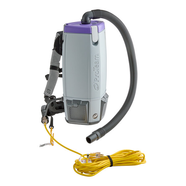 A ProTeam backpack vacuum cleaner with a hose attached.