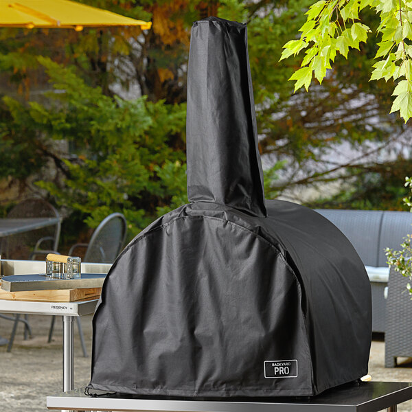 A black cover on a Backyard Pro countertop pizza oven.