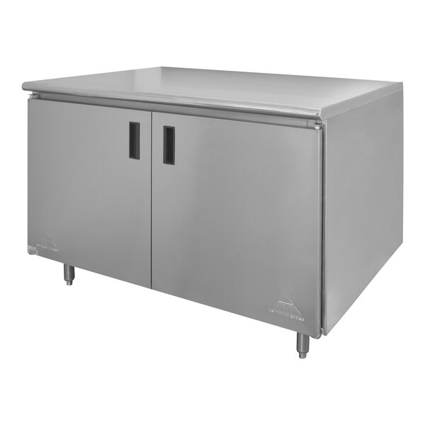 A stainless steel Advance Tabco work table with hinged doors and a midshelf.