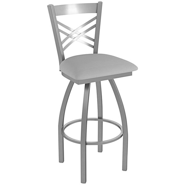 A gray Holland Bar Stool outdoor extra tall swivel bar stool with a Crossback seat and backrest.