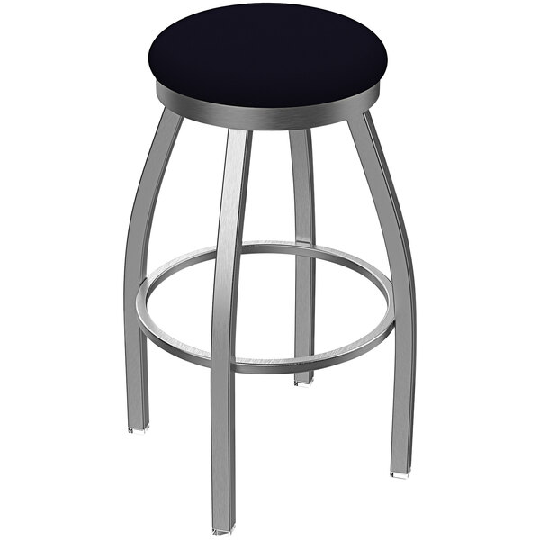 A Holland Bar Stool stainless steel extra tall outdoor restaurant bar stool with a Breeze Sapphire seat and swivel base.
