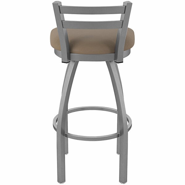 A Holland Bar Stool stainless steel outdoor counter stool with a tan cushioned seat.