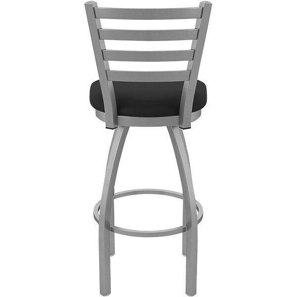 A Holland Bar Stool stainless steel outdoor bar stool with a black cushion and ladderback.