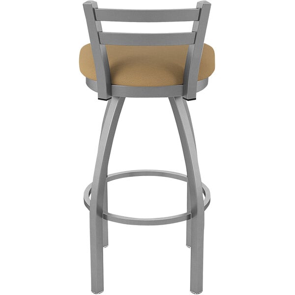 A Holland Bar Stool stainless steel outdoor bar stool with a tan cushion.