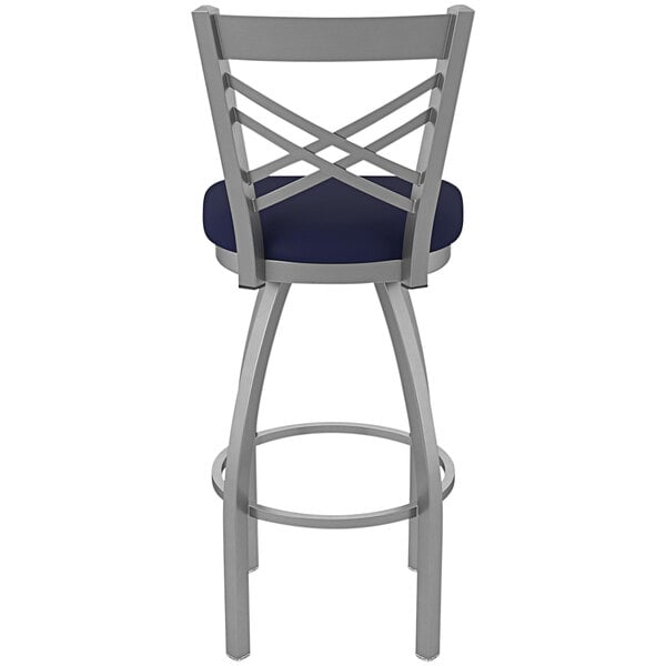A Holland Bar Stool outdoor extra tall swivel bar stool with a navy blue seat and back.