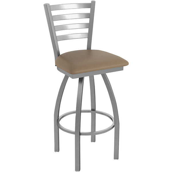 A Holland Bar Stool stainless steel outdoor counter stool with a tan cushion.