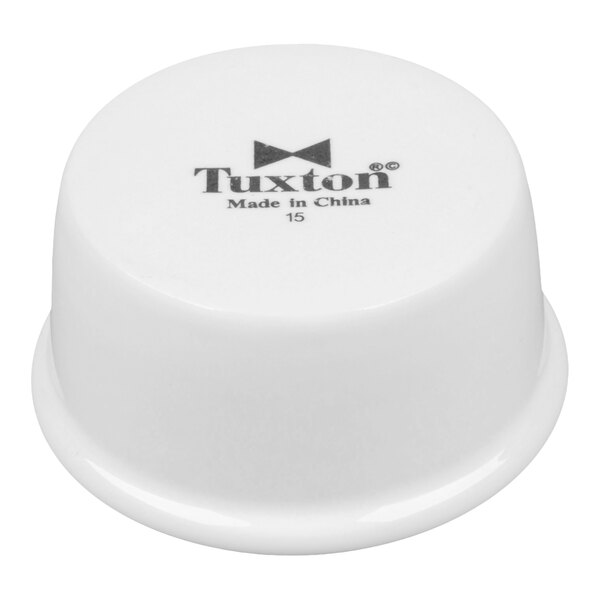 A white 2.5 oz. smooth china ramekin with the Tuxton logo on the bottom.