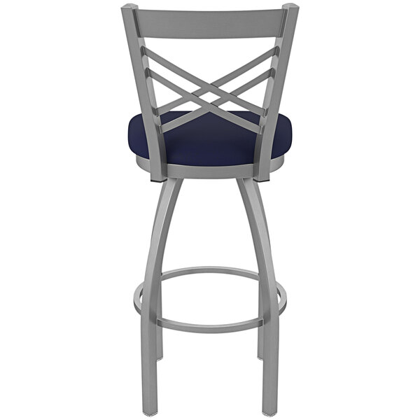 A Holland Bar Stool outdoor swivel bar stool with a navy blue seat and back.