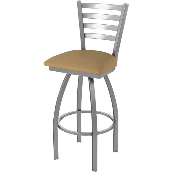 A Holland Bar Stool outdoor extra tall bar stool with a beige cushion and stainless steel legs.