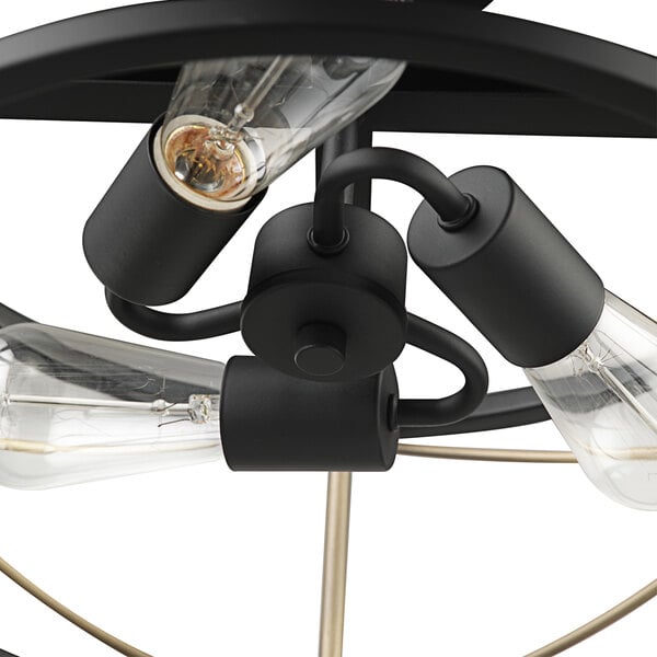 A Globe matte black and brass ceiling light fixture with three bulbs.