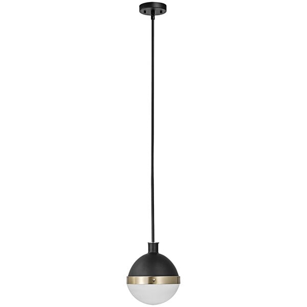 A black and brass Globe pendant light with white glass inside hanging in a restaurant.