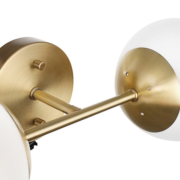 Two brass Globe Modern Glam wall sconces with frosted glass balls.