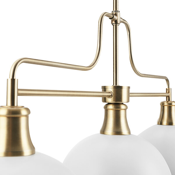 A Globe Matte White and Matte Brass chandelier with white glass shades.