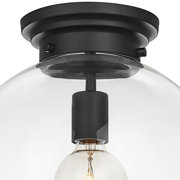 A Globe black glass semi-flush mount ceiling light with a bulb inside.