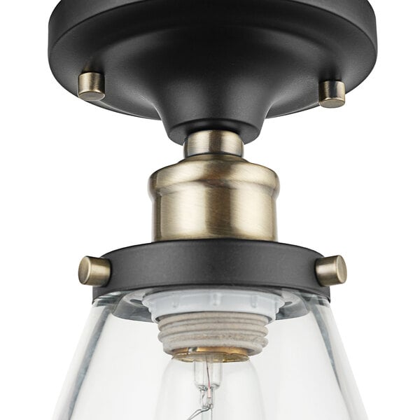 A Globe Industrial Dark Bronze and Antique Brass ceiling light with clear glass.