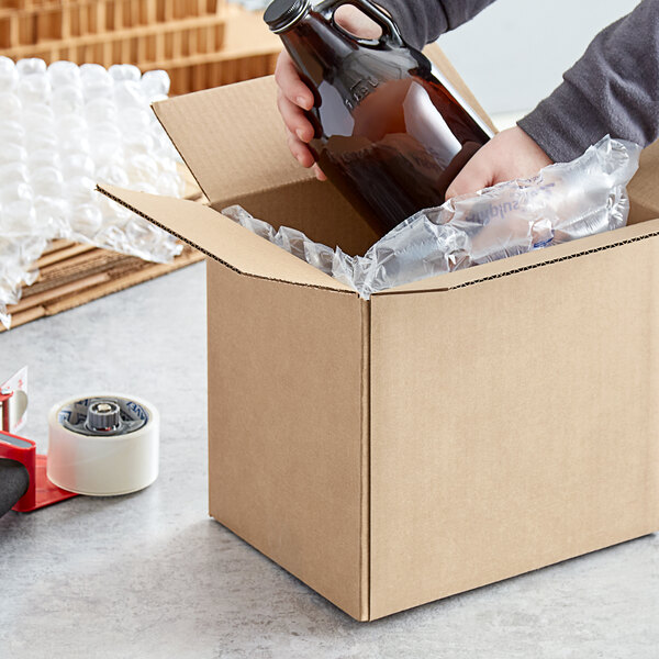 A person holding a bottle in a Lavex shipping box.