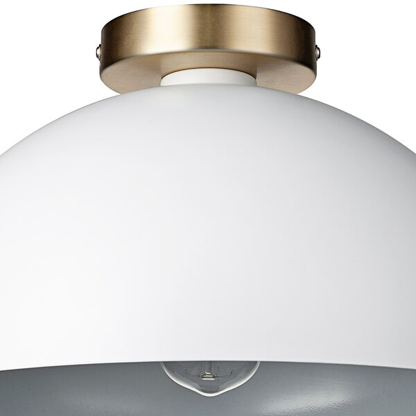 A close up of a white and gold Globe semi-flush mount light.