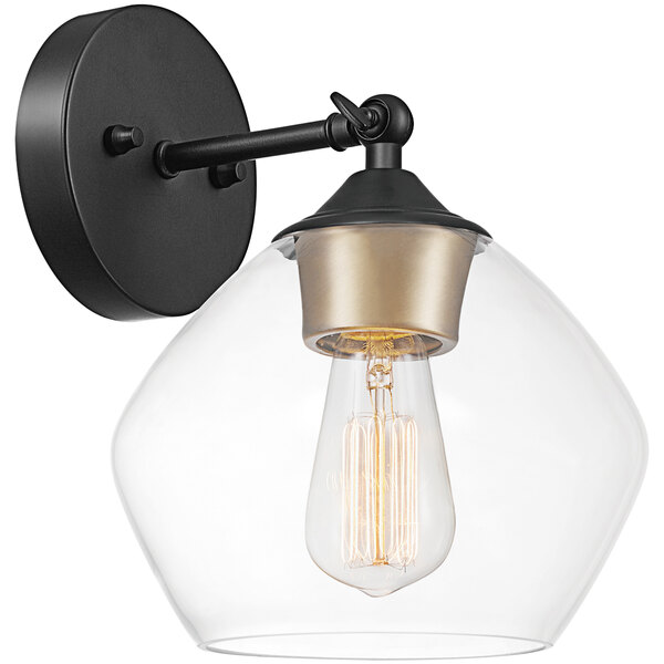 A Globe matte black and gold wall sconce with clear glass shade over an Edison bulb.