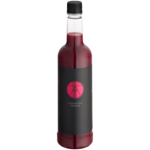 A case of Twisted Alchemy cold-pressed blood orange juice bottles on a table in a cocktail bar.