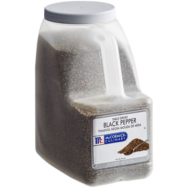 A plastic container with a white lid filled with McCormick Culinary Table Grind Black Pepper.