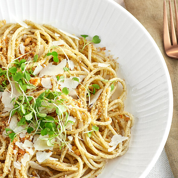 A white plate of spaghetti with McCormick Culinary Ground Sage and parmesan cheese.