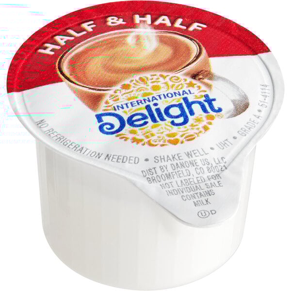 A container of International Delight Half and Half single serve cups on a counter.