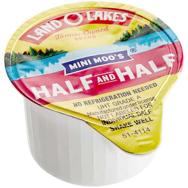 A case of 192 Land O Lakes Mini Moo's half and half single serve cups on a counter.