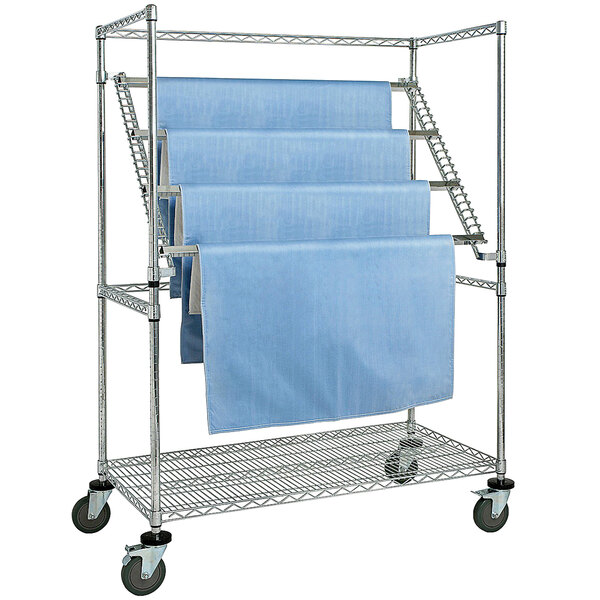 A Quantum chrome medical cart with blue sterile wrap on it.