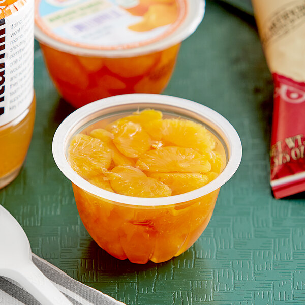 A plastic container of Dole Mandarin Oranges in juice with a red label.