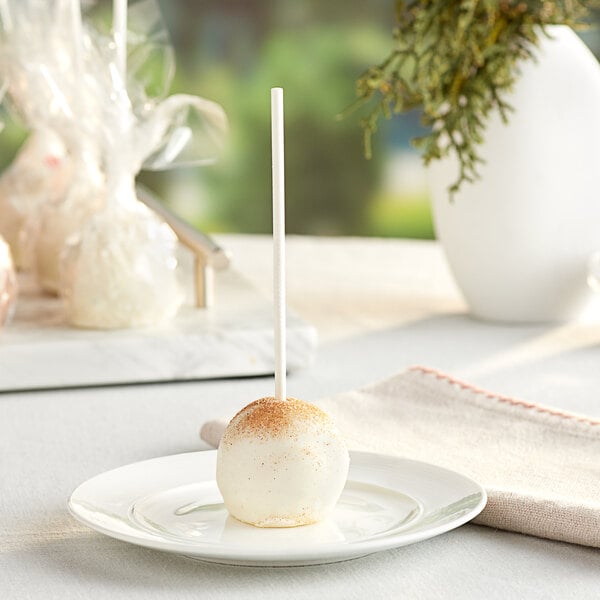 A Chalet Desserts cinnamon churro cake pop on a white plate.