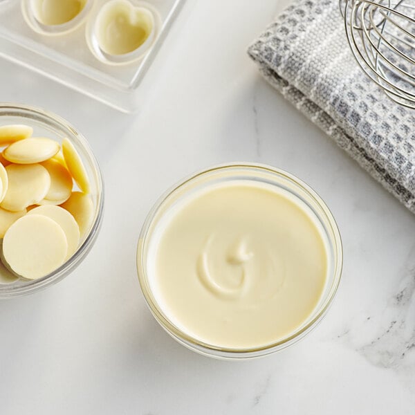 A bowl of white liquid white chocolate.